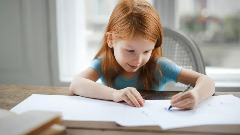 Girl drawing with crayon