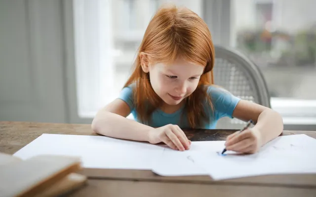 Girl drawing with crayon